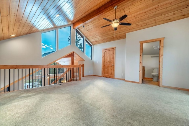 bonus room featuring beamed ceiling, carpet flooring, baseboards, and ceiling fan