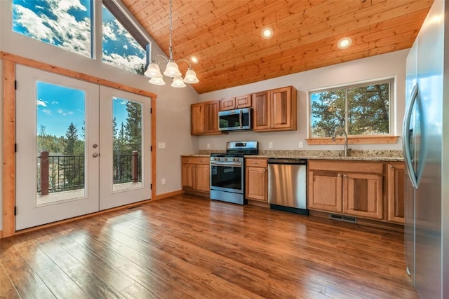 kitchen with stainless steel appliances, french doors, an inviting chandelier, light stone countertops, and wooden ceiling