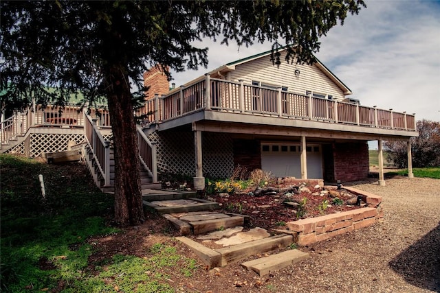 5795 County Road 78, Hayden, CO 81639 - rear view of property featuring a wooden deck, stairs, and a garage