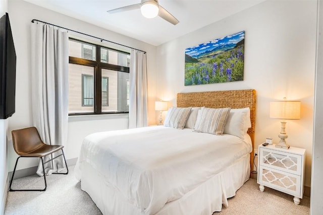 bedroom featuring light colored carpet and ceiling fan
