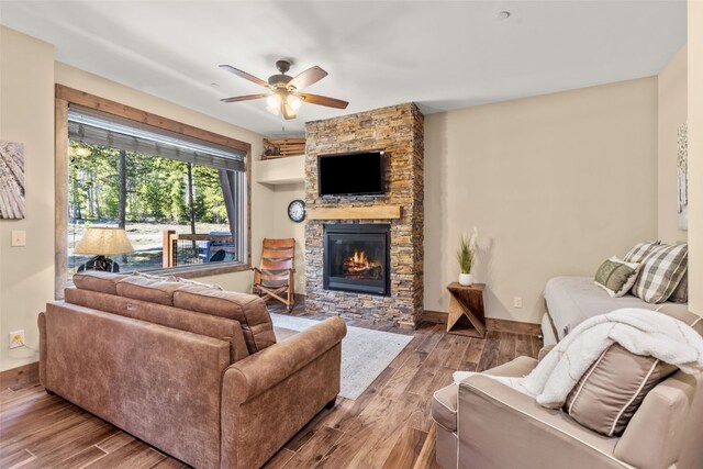 102 Lake Ridge Cir Unit 1887, Keystone, CO 80435 - living area with a stone fireplace, ceiling fan, wood finished floors, and baseboards