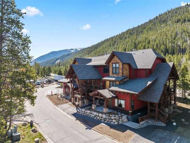 102 Lake Ridge Cir Unit 1887, Keystone, CO 80435 - rear view of property featuring a wooded view, a mountain view, and roof with shingles