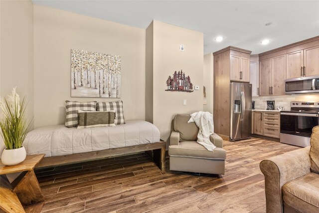 102 Lake Ridge Cir Unit 1887, Keystone, CO 80435 - bedroom featuring stainless steel fridge with ice dispenser, light wood-type flooring, and recessed lighting