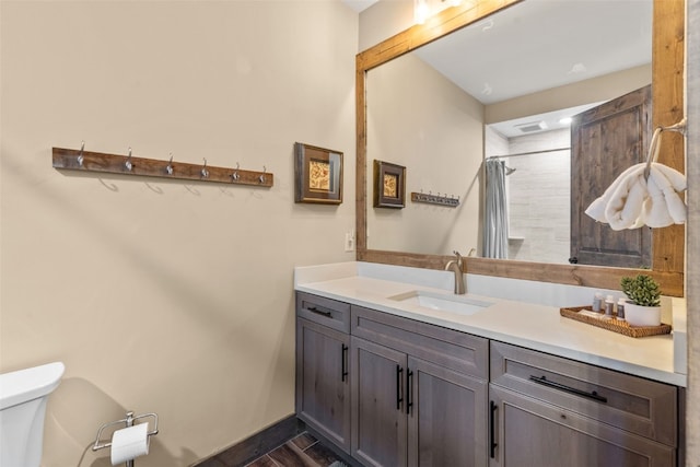 102 Lake Ridge Cir Unit 1887, Keystone, CO 80435 - full bath with toilet, vanity, curtained shower, baseboards, and wood finished floors