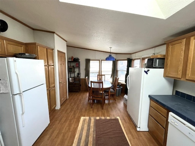315 E 1st St, Oak Creek, CO 80467 - kitchen featuring brown cabinets, ornamental molding, light wood-style floors, and white appliances