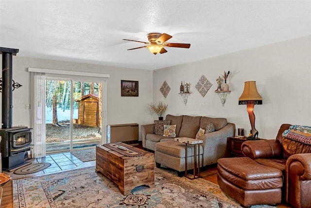 850 Georgia Pass, Lookout, Jefferson, CO 80456 - living room featuring light wood-style floors, a wood stove, and ceiling fan