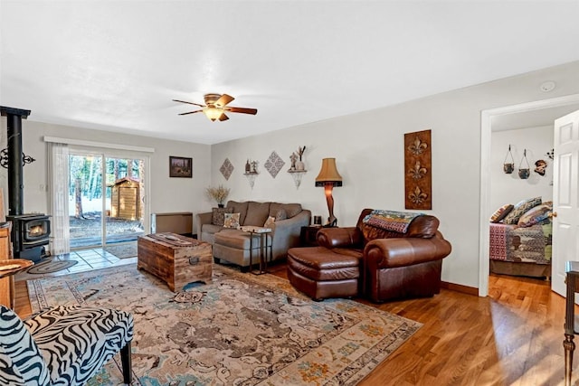850 Georgia Pass, Lookout, Jefferson, CO 80456 - living room featuring a wood stove, light wood finished floors, and ceiling fan
