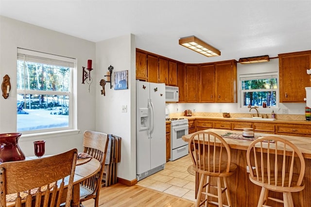 850 Georgia Pass, Lookout, Jefferson, CO 80456 - kitchen featuring light countertops, white appliances, a sink, and a healthy amount of sunlight