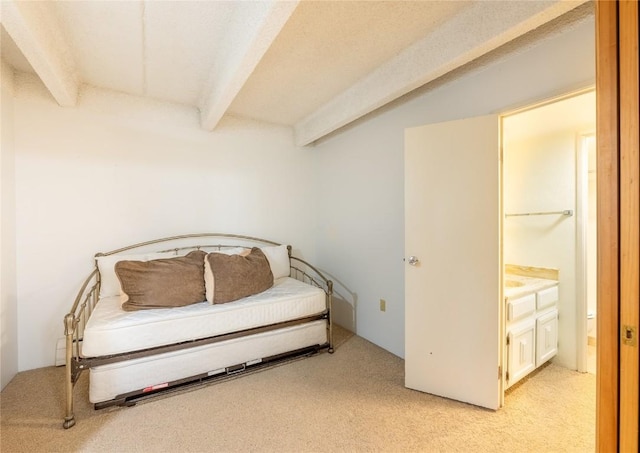 bedroom featuring beamed ceiling and light carpet