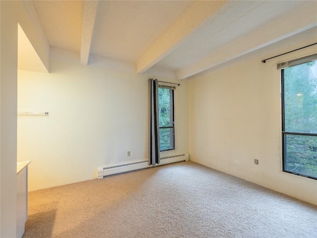 spare room featuring baseboard heating, carpet flooring, and beam ceiling