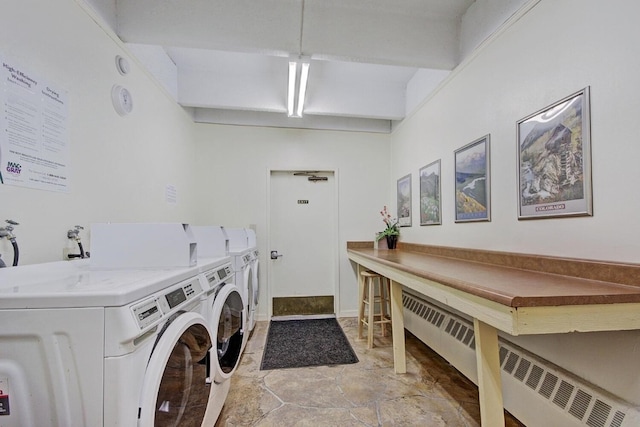 common laundry area with radiator heating unit, stone finish floor, and independent washer and dryer