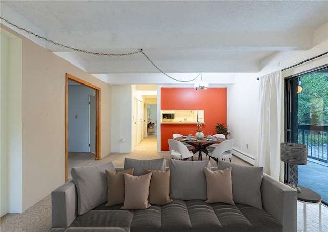 carpeted living area featuring a baseboard radiator and a textured ceiling