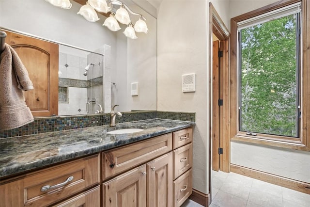 17 James Ct, Dillon, CO 80435 - full bathroom featuring vanity, a tile shower, tile patterned flooring, and a chandelier