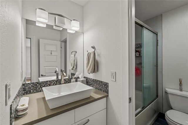 21 Cypress Ct, Steamboat Springs, CO 80487 - bathroom with toilet, vanity, and shower / bath combination with glass door