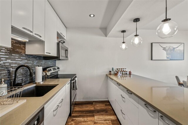 21 Cypress Ct, Steamboat Springs, CO 80487 - kitchen featuring stainless steel appliances, a sink, tasteful backsplash, dark wood-style floors, and hanging light fixtures