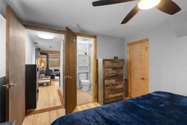 2349 Michigan Hill Rd, Jefferson, CO 80456 - bedroom with light wood finished floors, connected bathroom, and a ceiling fan