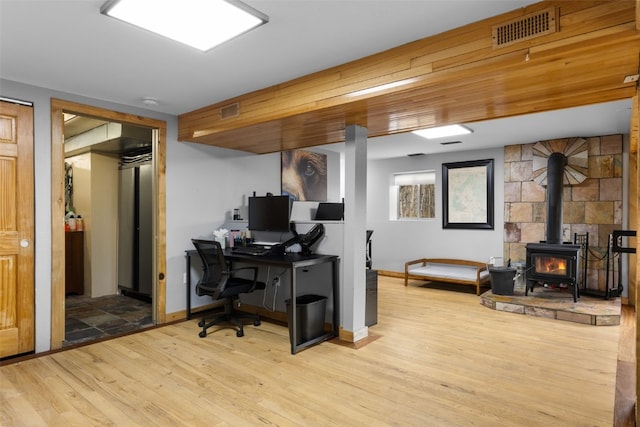 2349 Michigan Hill Rd, Jefferson, CO 80456 - home office with a wood stove, wood finished floors, and baseboards