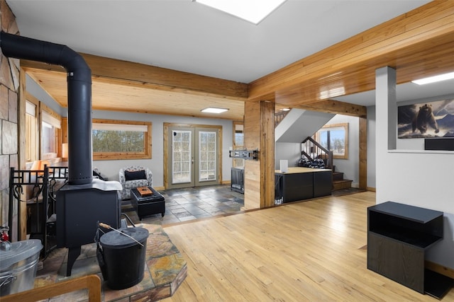 2349 Michigan Hill Rd, Jefferson, CO 80456 - living area featuring a wood stove, stairway, wood-type flooring, and plenty of natural light