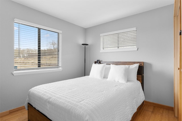 2349 Michigan Hill Rd, Jefferson, CO 80456 - bedroom featuring wood finished floors, multiple windows, and baseboards