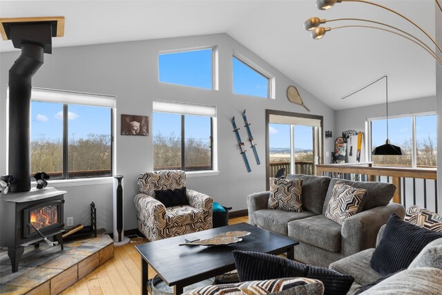2349 Michigan Hill Rd, Jefferson, CO 80456 - living room with a wood stove, light wood finished floors, plenty of natural light, and high vaulted ceiling