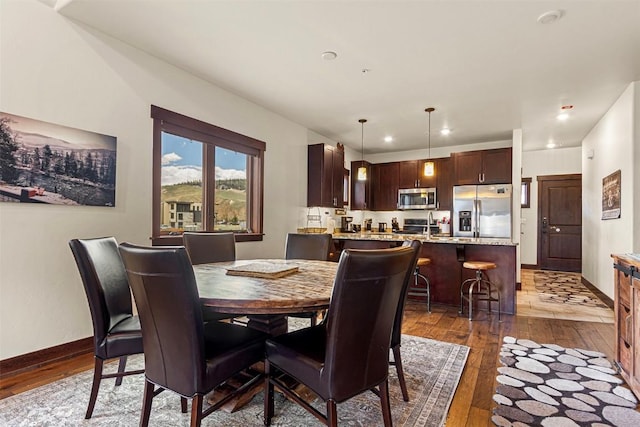 830 Blue River Pkwy Unit 203, Silverthorne, CO 80498 - dining room with dark wood-style flooring, recessed lighting, and baseboards