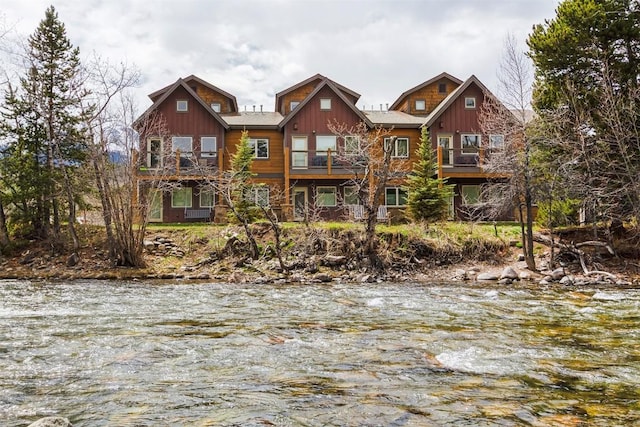 830 Blue River Pkwy Unit 203, Silverthorne, CO 80498 - view of front facade featuring a balcony, board and batten siding, and a water view