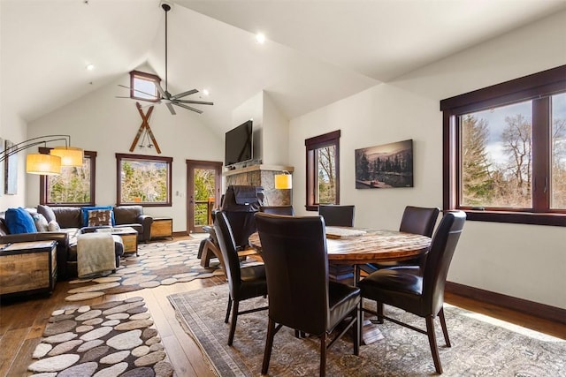 830 Blue River Pkwy Unit 203, Silverthorne, CO 80498 - dining space featuring hardwood / wood-style floors, high vaulted ceiling, a ceiling fan, and baseboards