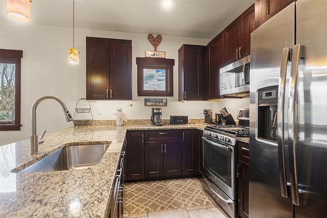 830 Blue River Pkwy Unit 203, Silverthorne, CO 80498 - kitchen with stainless steel appliances, a sink, light stone counters, and decorative light fixtures