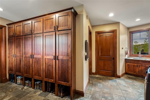 1115 Steamboat Blvd, Steamboat Springs, CO 80487 - mudroom featuring baseboards, stone tile flooring, a sink, and recessed lighting