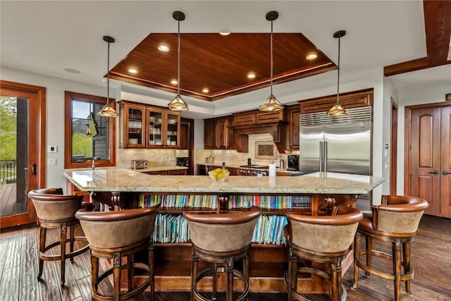 1115 Steamboat Blvd, Steamboat Springs, CO 80487 - bar with built in fridge, dark wood-style floors, a tray ceiling, tasteful backsplash, and recessed lighting