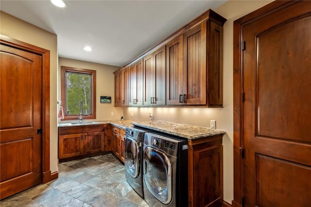 1115 Steamboat Blvd, Steamboat Springs, CO 80487 - laundry area with cabinet space, dark stone finish floors, washer and dryer, and recessed lighting