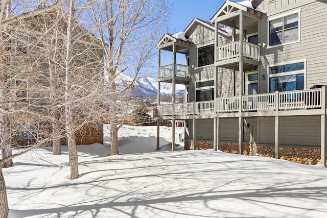 view of snow covered rear of property