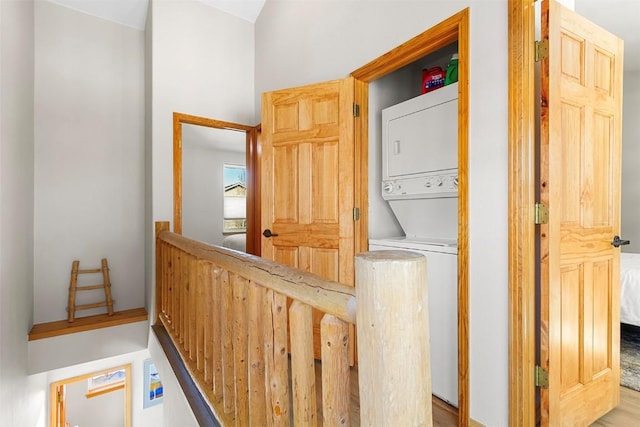 washroom featuring laundry area and stacked washer and dryer