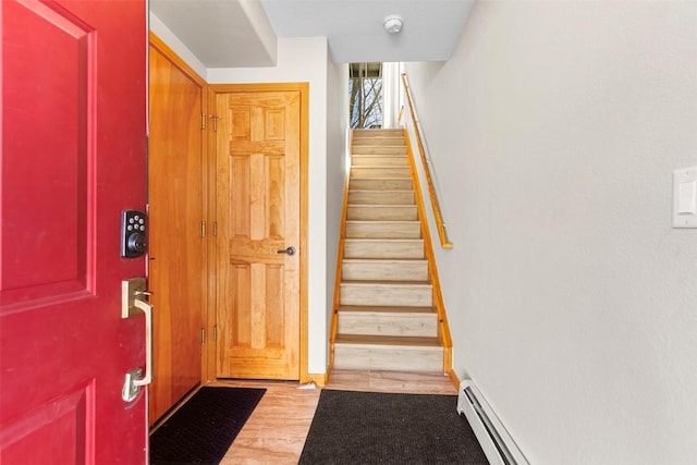 stairway with wood finished floors and baseboards