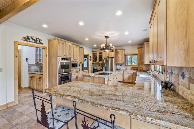 kitchen featuring decorative backsplash, light stone countertops, beam ceiling, a kitchen island, and stainless steel appliances