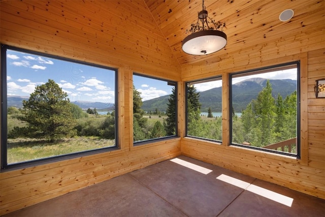 unfurnished sunroom featuring a water and mountain view, wood ceiling, and lofted ceiling