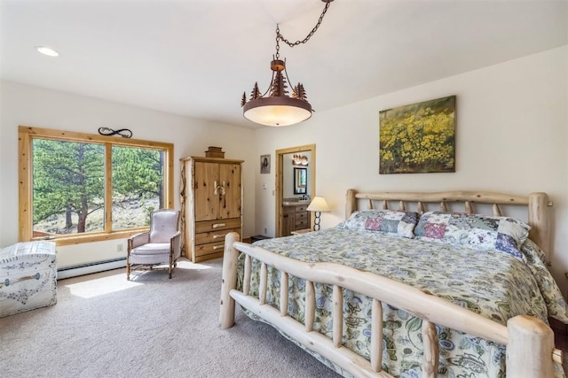 bedroom with carpet floors and a baseboard heating unit