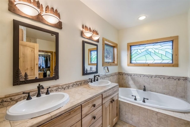 bathroom featuring vanity and a relaxing tiled tub