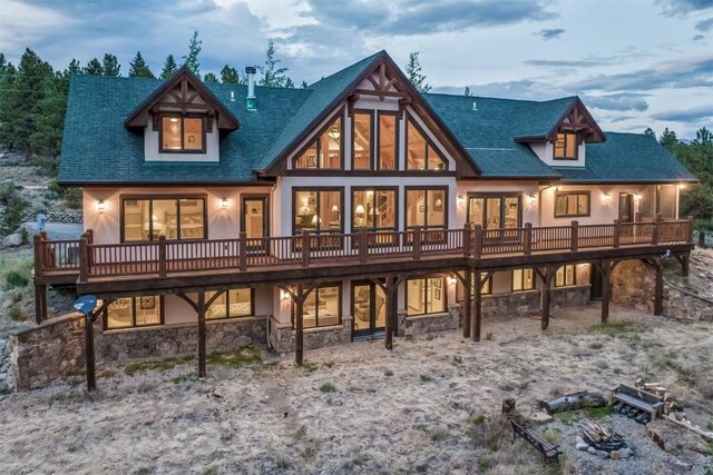 back house at dusk with a deck