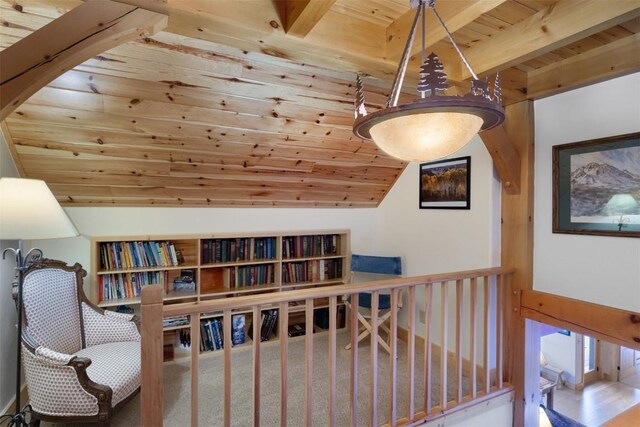 interior space featuring lofted ceiling with beams and wooden ceiling