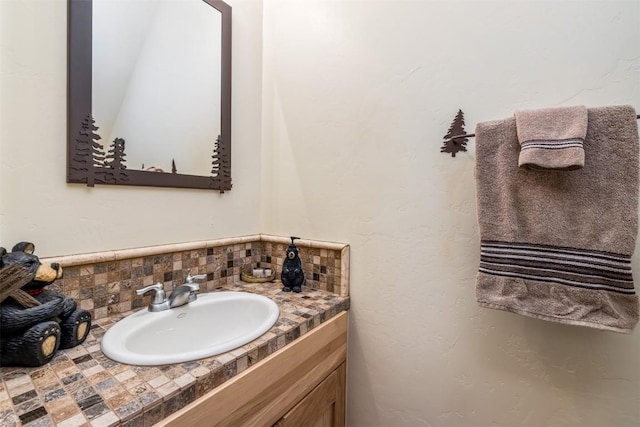 bathroom featuring vanity and tasteful backsplash