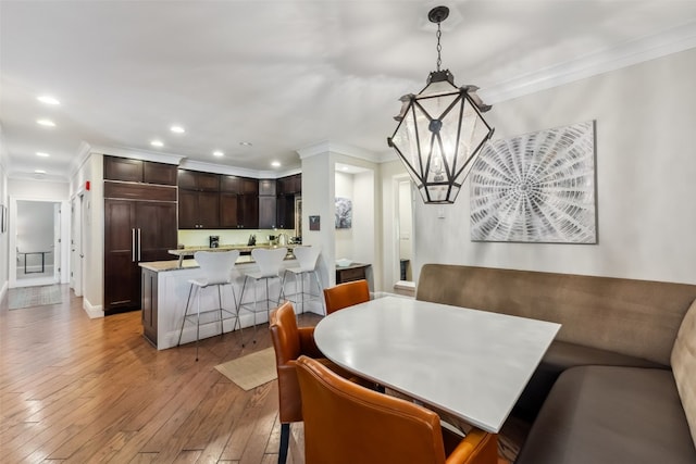 1207 W Keystone Rd Unit 2701, Keystone, CO 80435 - dining room featuring crown molding, light wood-type flooring, recessed lighting, and bar