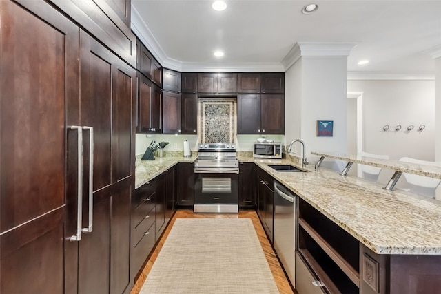 1207 W Keystone Rd Unit 2701, Keystone, CO 80435 - kitchen with appliances with stainless steel finishes, a peninsula, crown molding, light stone countertops, and dark brown cabinetry