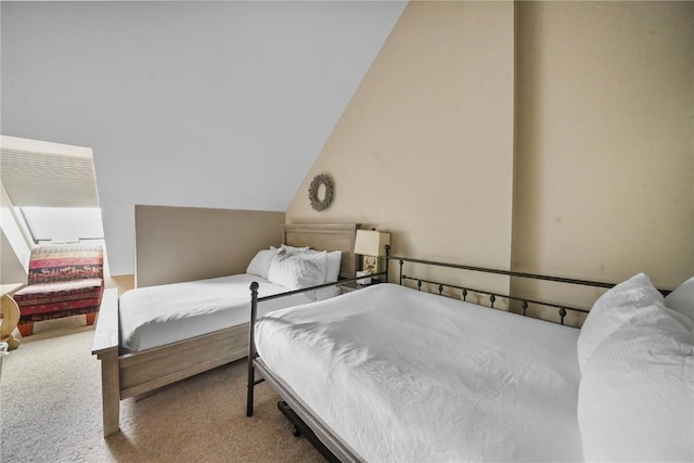 carpeted bedroom featuring lofted ceiling