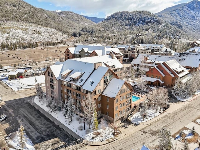 snowy aerial view with a mountain view