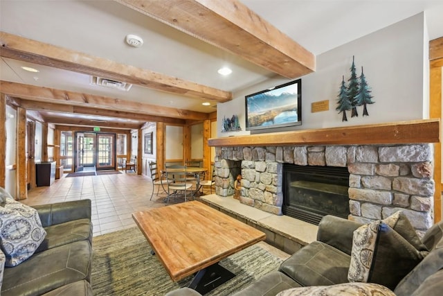 living room with beamed ceiling, recessed lighting, tile patterned floors, visible vents, and a stone fireplace