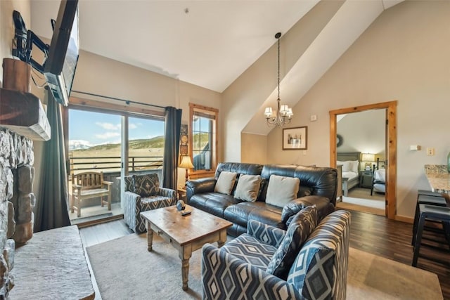 living area featuring an inviting chandelier, wood finished floors, and vaulted ceiling