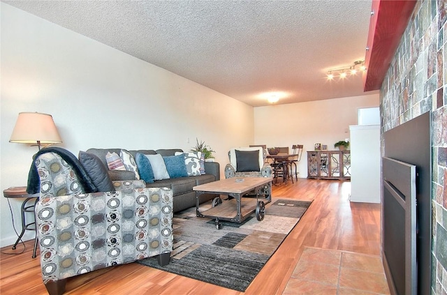 living room with wood finished floors and a textured ceiling