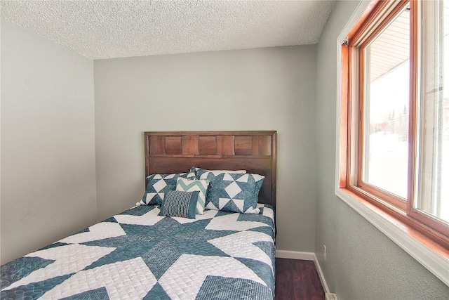 bedroom with wood finished floors and a textured ceiling
