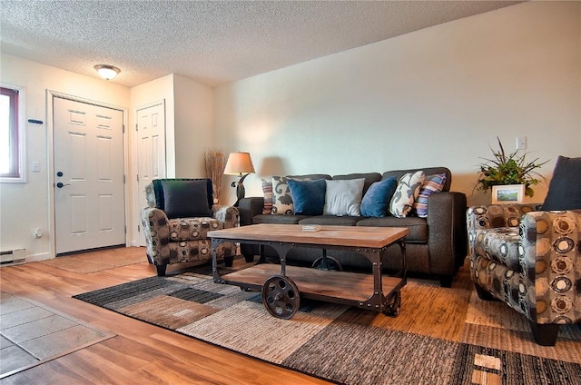 living area featuring light wood-style flooring and a textured ceiling